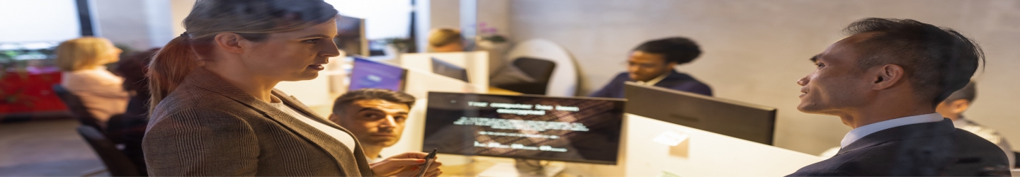 woman and man speaking in front of computer